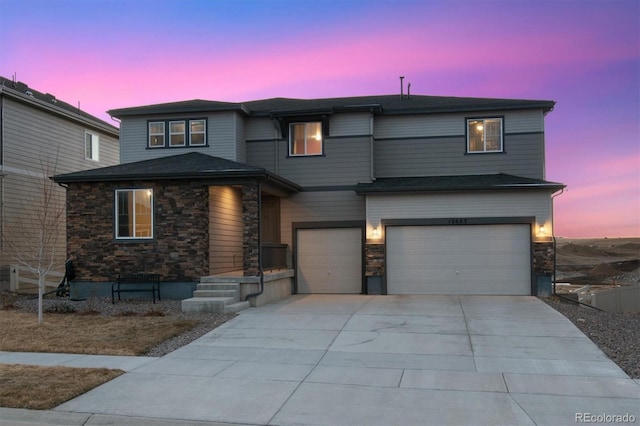 view of front facade featuring a garage, stone siding, and driveway