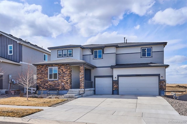 view of front of property with an attached garage, stone siding, and driveway