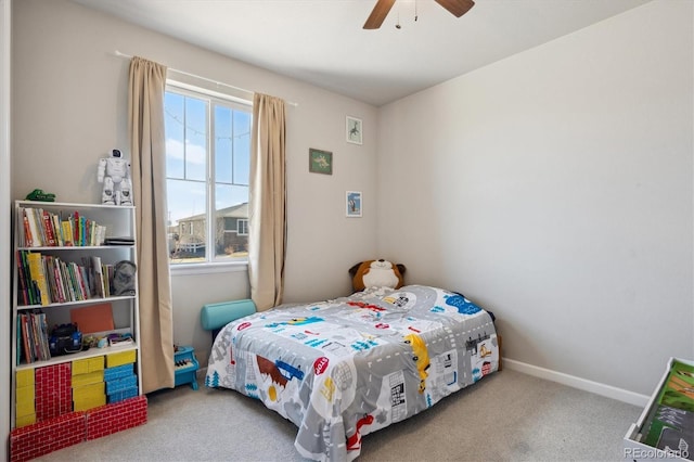 carpeted bedroom with a ceiling fan and baseboards