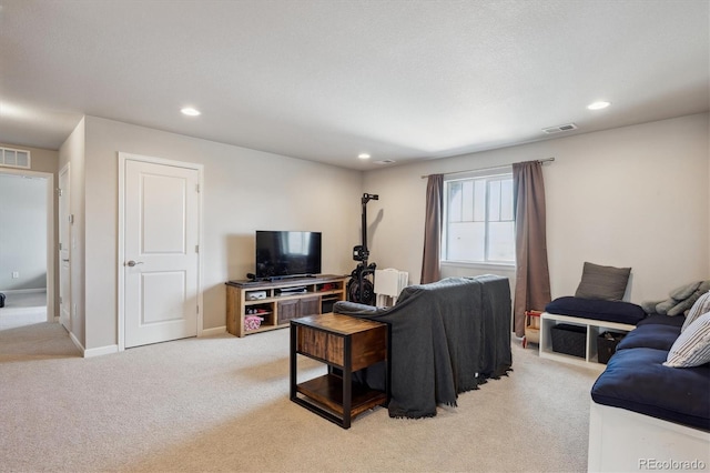 living area featuring baseboards, recessed lighting, visible vents, and light colored carpet