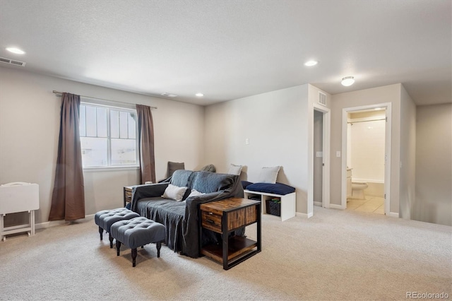 living room with light colored carpet, visible vents, baseboards, and recessed lighting