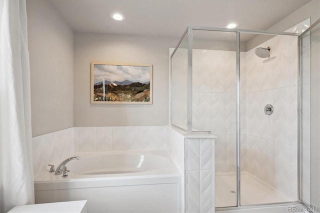 full bath featuring a garden tub, a shower stall, and recessed lighting