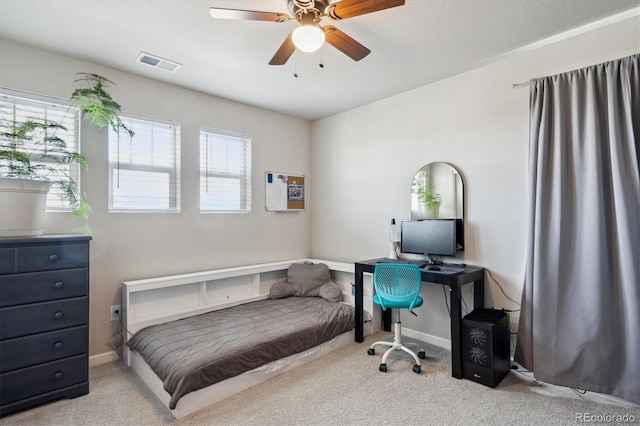 carpeted bedroom with baseboards, visible vents, and ceiling fan