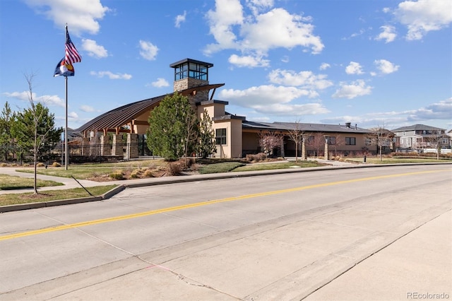 view of building exterior with fence