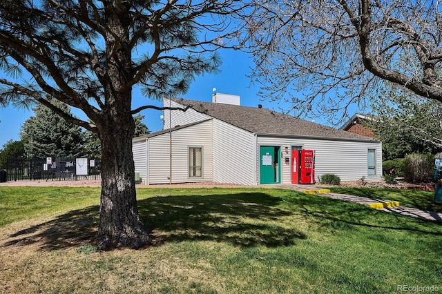 mid-century modern home featuring a shingled roof and a chimney