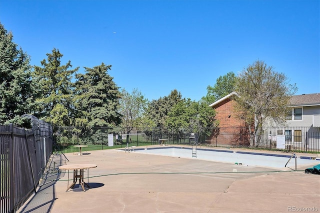 view of pool featuring fence and a patio