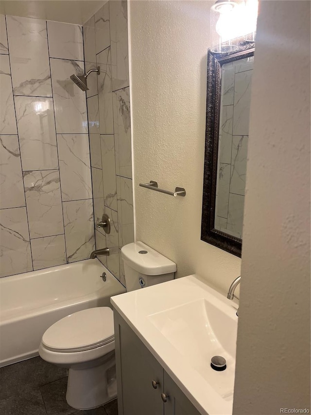 full bathroom featuring vanity, toilet, tile patterned floors, and tiled shower / bath combo