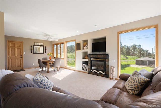 713 Aspen Rd, Golden, CO 80401 - living room featuring light carpet, a ceiling fan, and a tiled fireplace