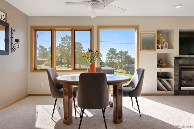 713 Aspen Rd, Golden, CO 80401 - carpeted dining area featuring a fireplace and a ceiling fan