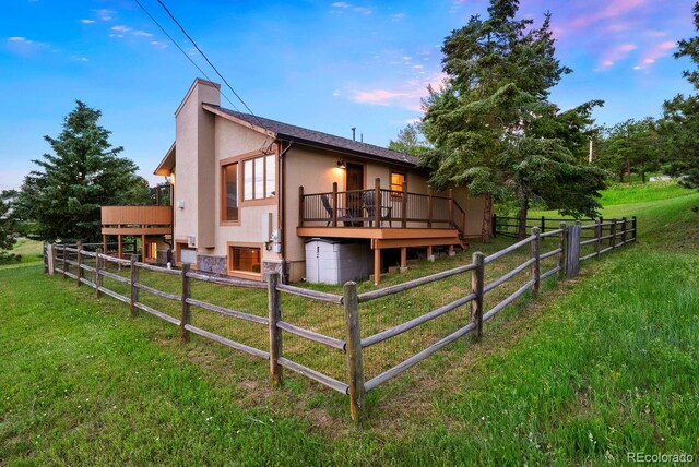 713 Aspen Rd, Golden, CO 80401 - property exterior at dusk featuring stucco siding and a wooden deck