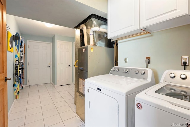 713 Aspen Rd, Golden, CO 80401 - laundry area featuring independent washer and dryer, cabinet space, and light tile patterned flooring