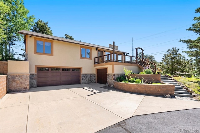 713 Aspen Rd, Golden, CO 80401 - view of front of house with an attached garage, stairs, stucco siding, stone siding, and concrete driveway