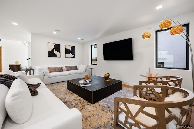 living area featuring wood finished floors and recessed lighting