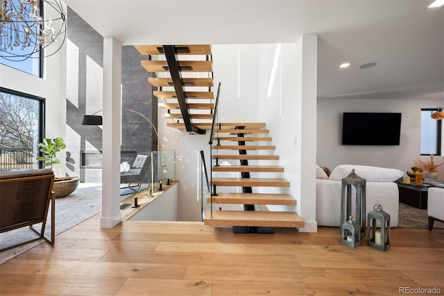 staircase with hardwood / wood-style flooring and recessed lighting