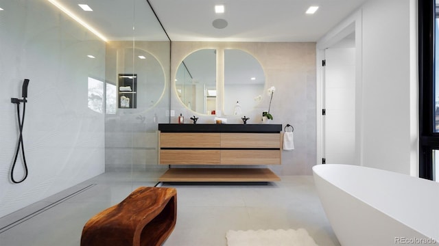 full bathroom with tile patterned flooring, walk in shower, a freestanding bath, vanity, and tile walls