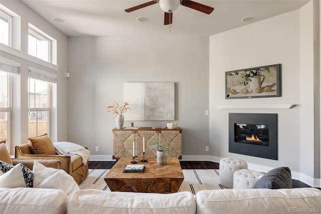 living room with ceiling fan and light hardwood / wood-style flooring