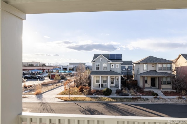 view of front facade featuring covered porch and solar panels