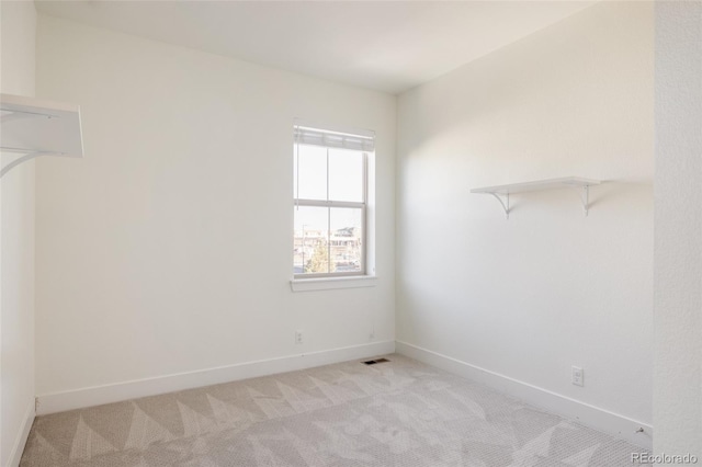 spacious closet featuring light colored carpet