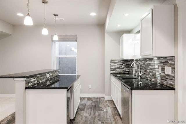 kitchen featuring dishwasher, hanging light fixtures, dark hardwood / wood-style flooring, sink, and white cabinetry