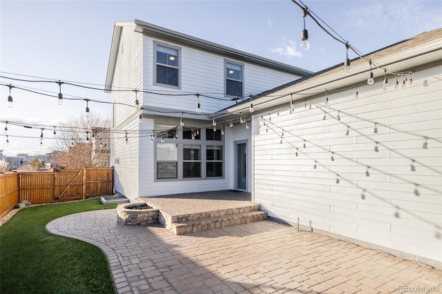 back of house with a patio and an outdoor fire pit