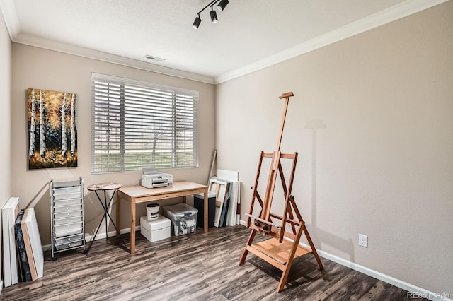 home office featuring baseboards, ornamental molding, wood finished floors, and visible vents