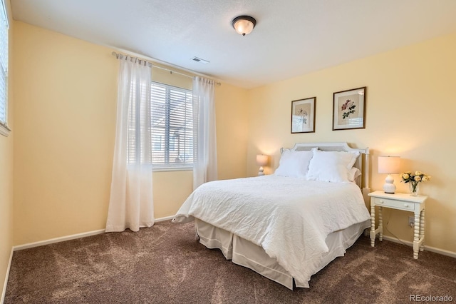 bedroom featuring baseboards, visible vents, and carpet