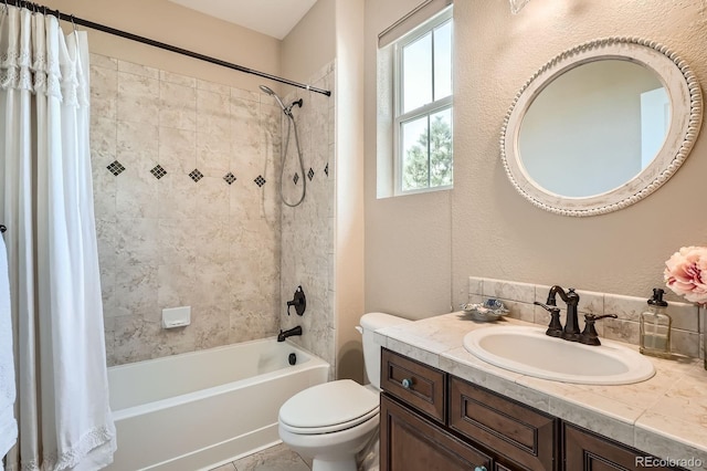 bathroom with vanity, shower / bath combo, and toilet
