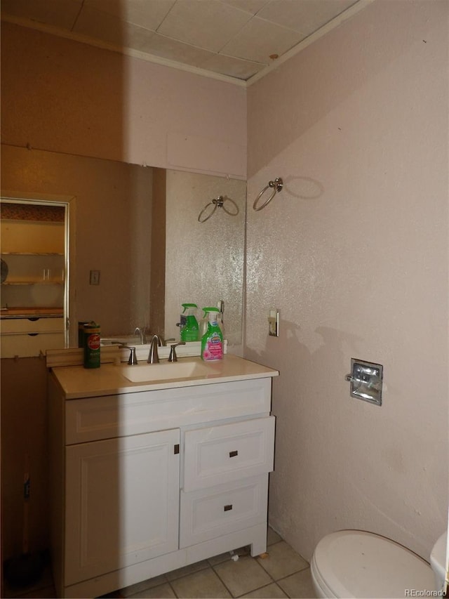 bathroom featuring tile patterned floors, toilet, and vanity