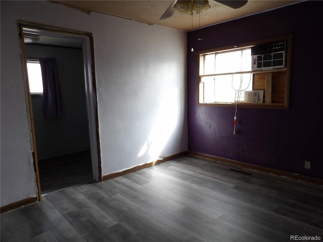 spare room featuring baseboards, wood finished floors, a textured ceiling, and ceiling fan