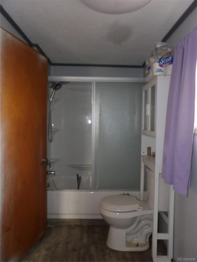 full bathroom featuring wood finished floors, toilet, and bathtub / shower combination