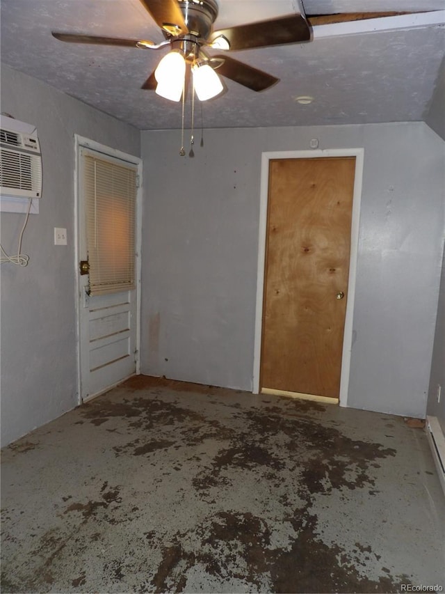 interior space with a wall mounted air conditioner and ceiling fan