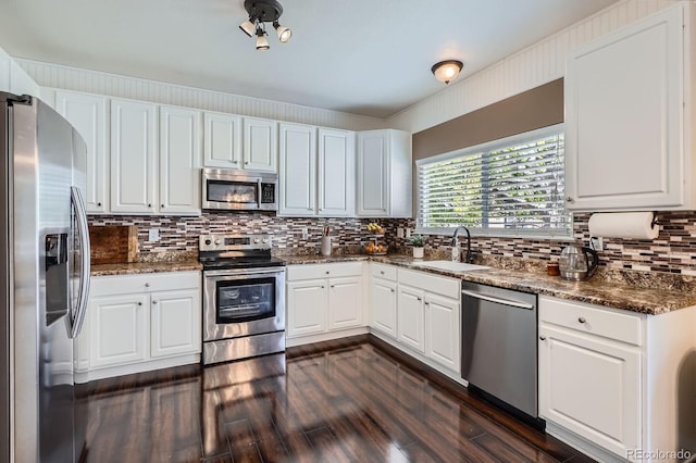 1179 S Fultondale Cir, Aurora, CO 80018 - kitchen with appliances with stainless steel finishes, a sink, tasteful backsplash, dark wood-style flooring, and white cabinets