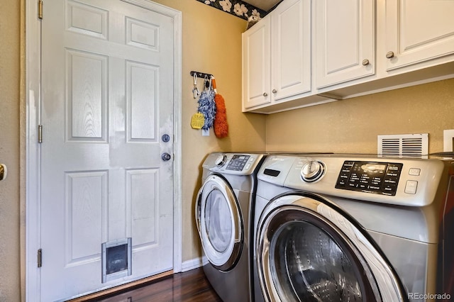 1179 S Fultondale Cir, Aurora, CO 80018 - laundry room featuring cabinet space, washing machine and dryer, dark wood-type flooring, and baseboards