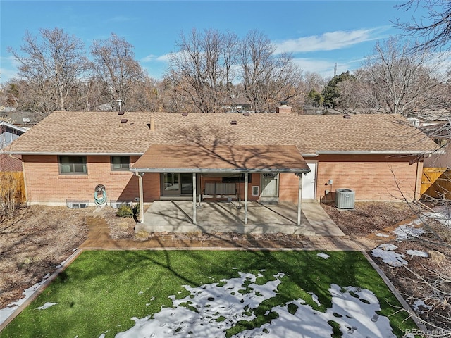 back of property featuring a patio, central air condition unit, and a lawn