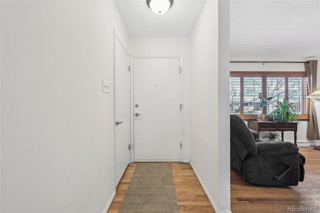 corridor with hardwood / wood-style floors