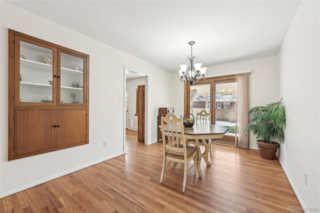 dining room featuring an inviting chandelier and light wood-type flooring