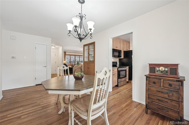 dining room featuring light hardwood / wood-style flooring and a chandelier