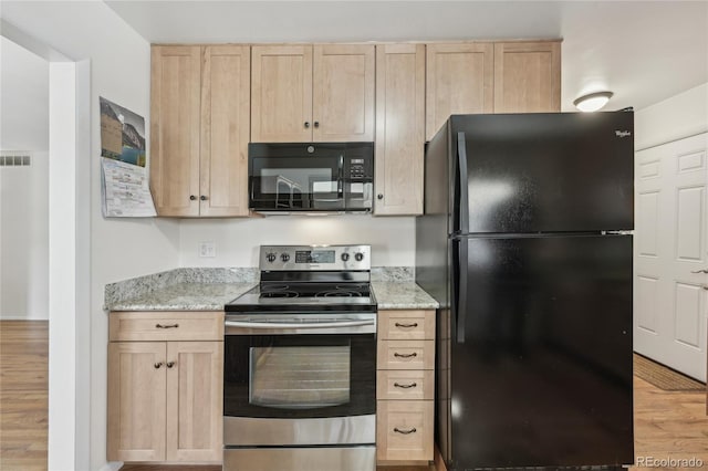 kitchen featuring light stone countertops, light hardwood / wood-style flooring, light brown cabinets, and black appliances