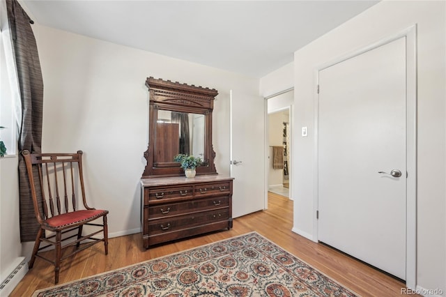 sitting room featuring light hardwood / wood-style floors and a baseboard heating unit