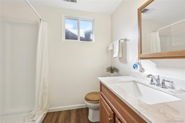 bathroom featuring vanity, toilet, curtained shower, and hardwood / wood-style floors