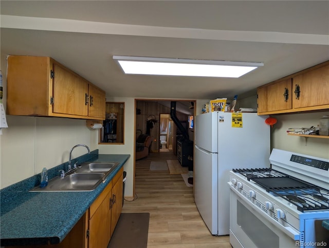 2117 Badger Creek Rd, Hartsel, CO 80449 - kitchen featuring white appliances, light wood-style flooring, dark countertops, and brown cabinetry