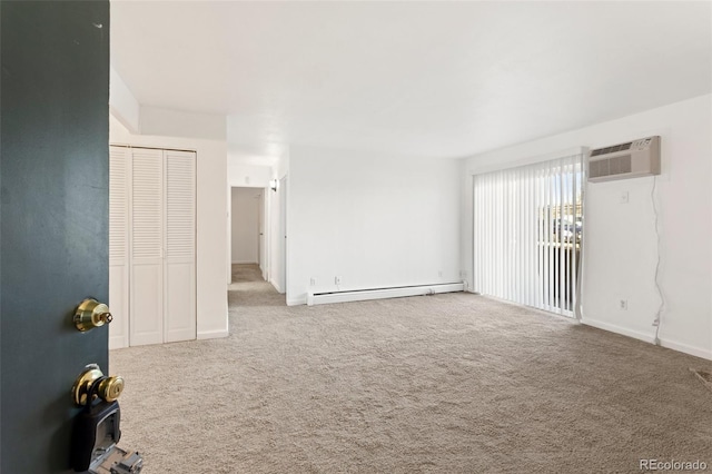 unfurnished room with baseboards, a baseboard heating unit, an AC wall unit, and carpet flooring