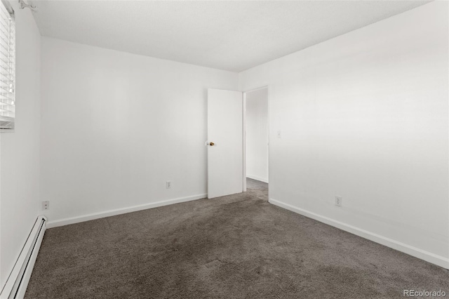 carpeted spare room featuring a baseboard radiator and baseboards