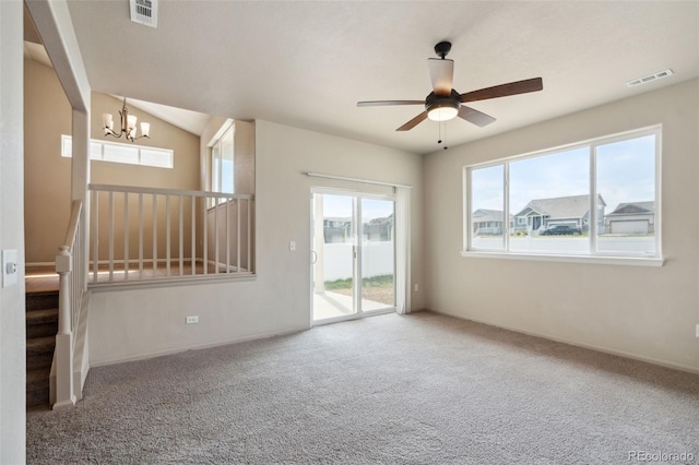 unfurnished living room featuring a chandelier, a ceiling fan, and carpet floors