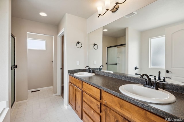 full bathroom with double vanity and a stall shower