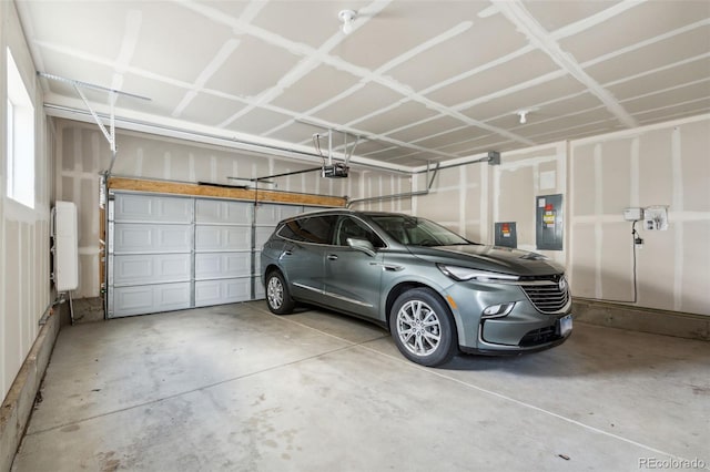 garage with electric panel and a garage door opener