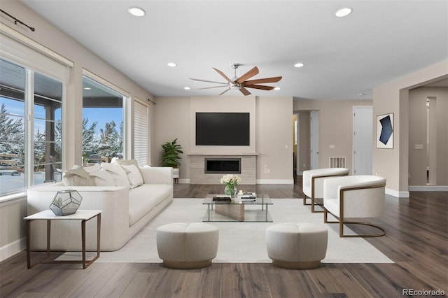 living room with ceiling fan and hardwood / wood-style flooring