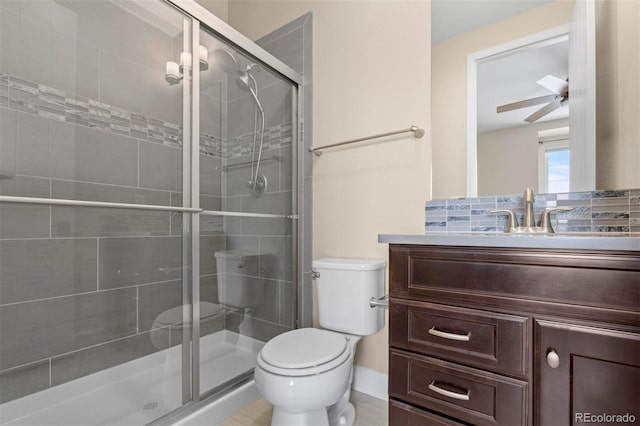 bathroom with an enclosed shower, ceiling fan, toilet, and vanity