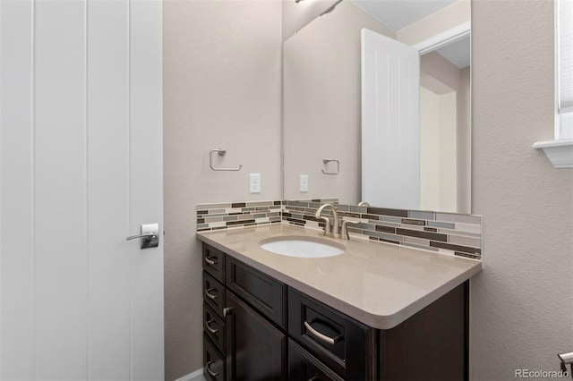 bathroom featuring decorative backsplash and vanity