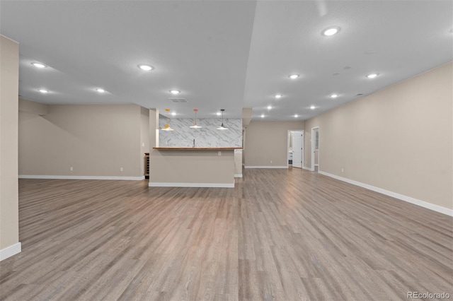 unfurnished living room with light hardwood / wood-style flooring